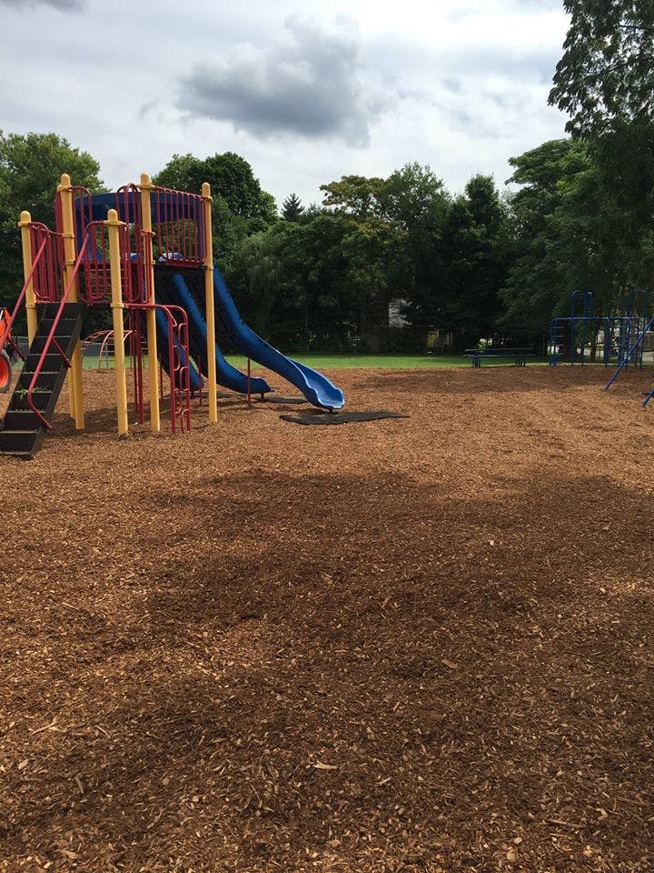 Playground with slides and climbing structures on wood chips