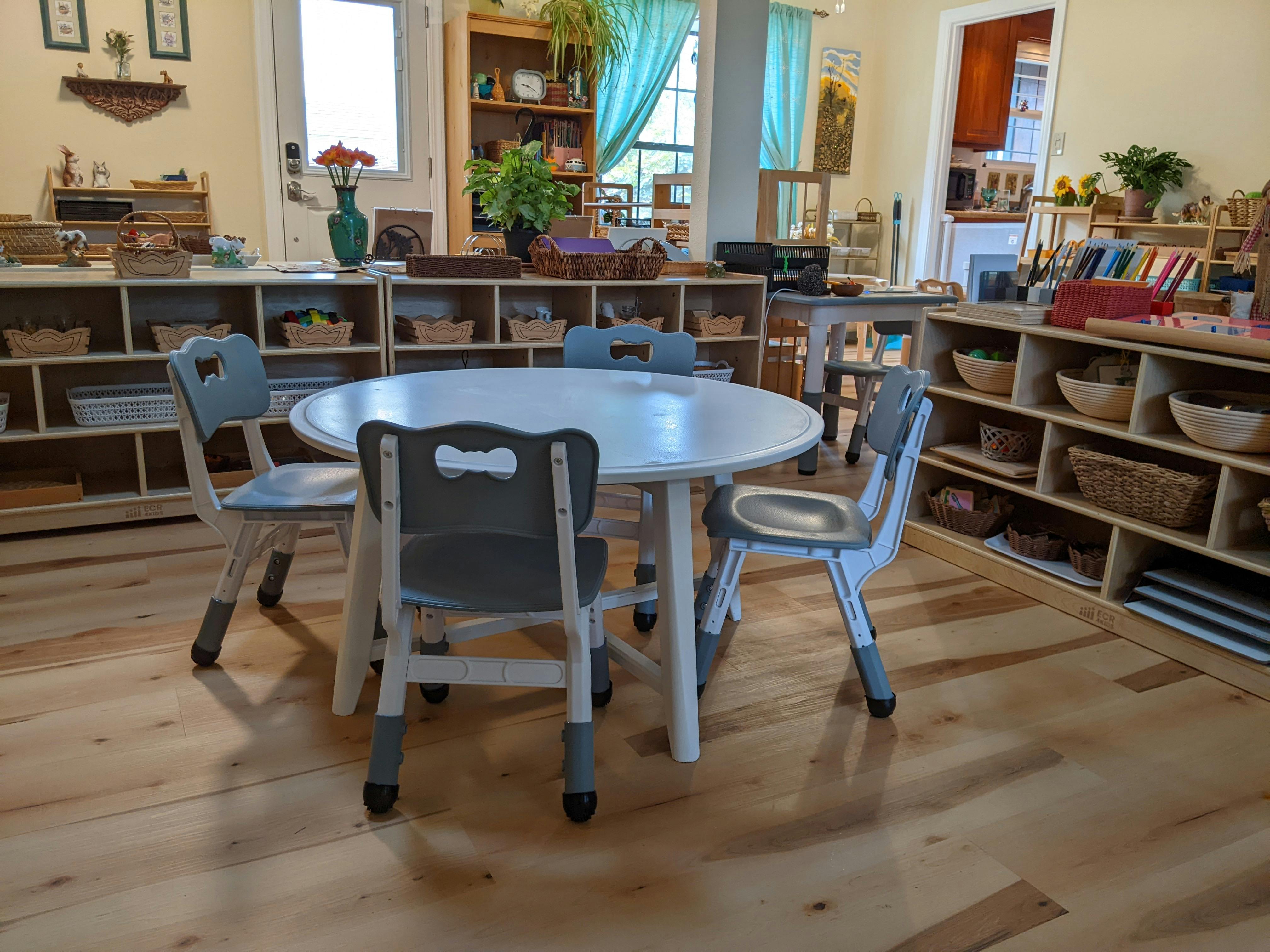 Small round table with four chairs in a classroom