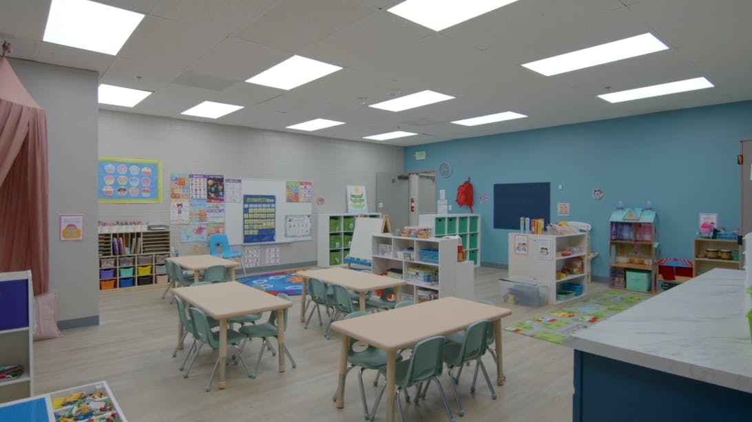 Empty classroom with small tables and chairs