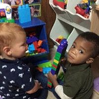 Two children playing with colorful toys