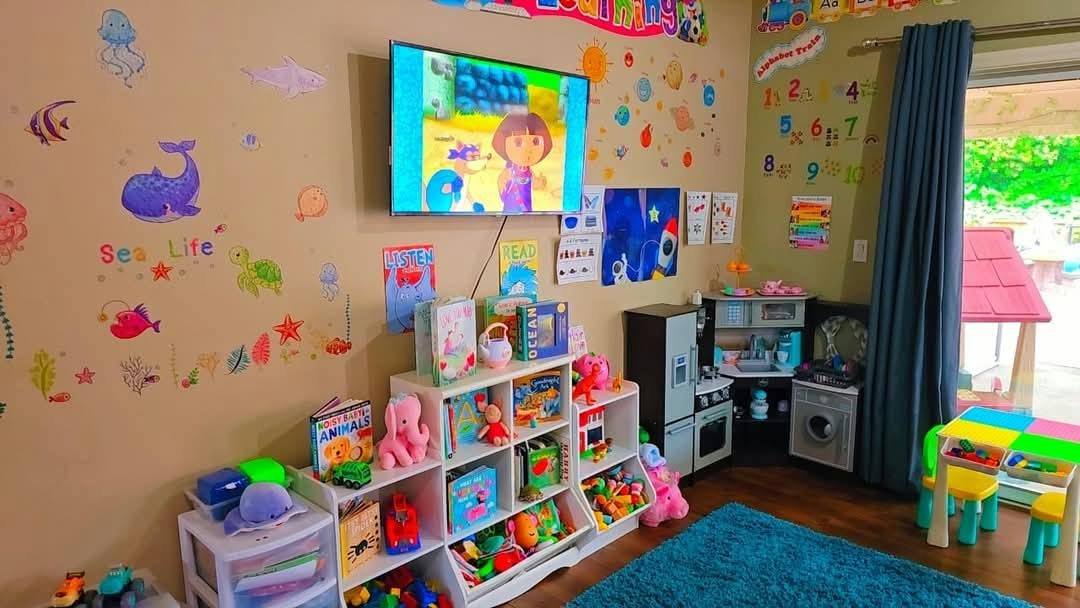 Colorful playroom with a television and children's activity furniture