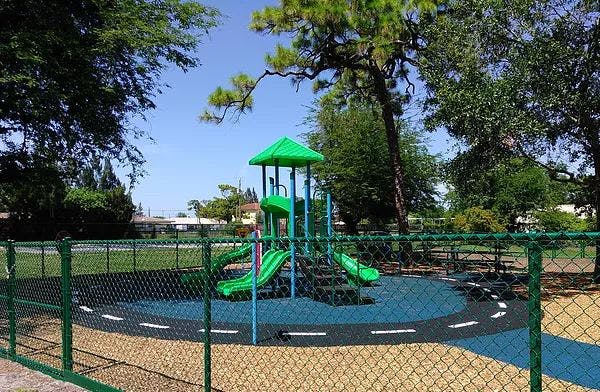 Playground with green slides and blue ground