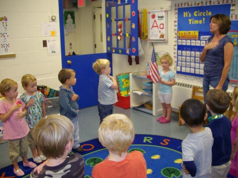 Person leading children in a classroom