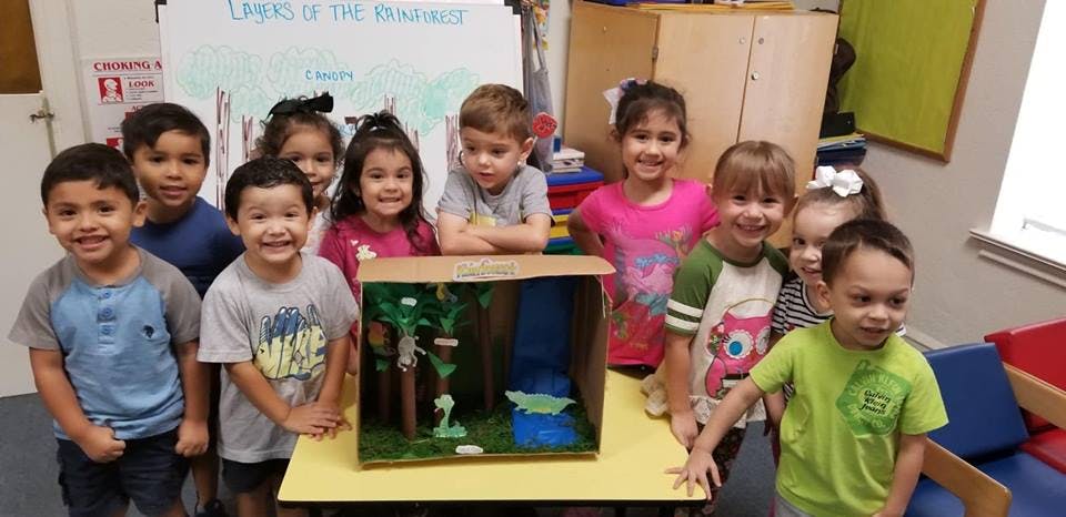 Group of children standing around a diorama