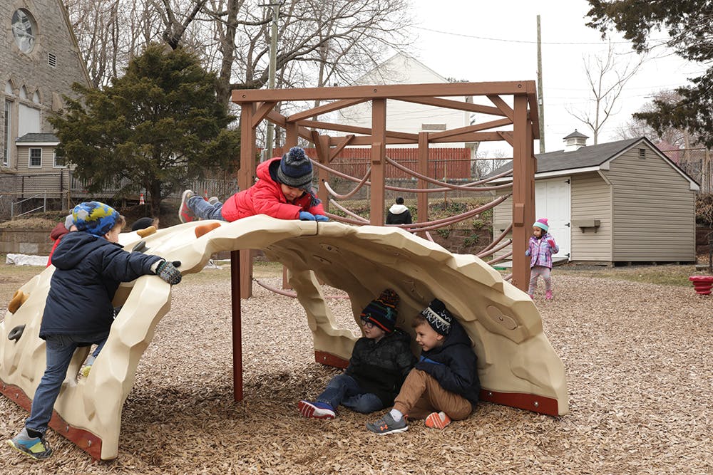 Children playing on a climbing structure in a playground