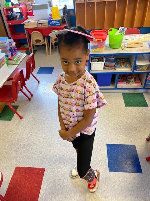 Child standing in a classroom