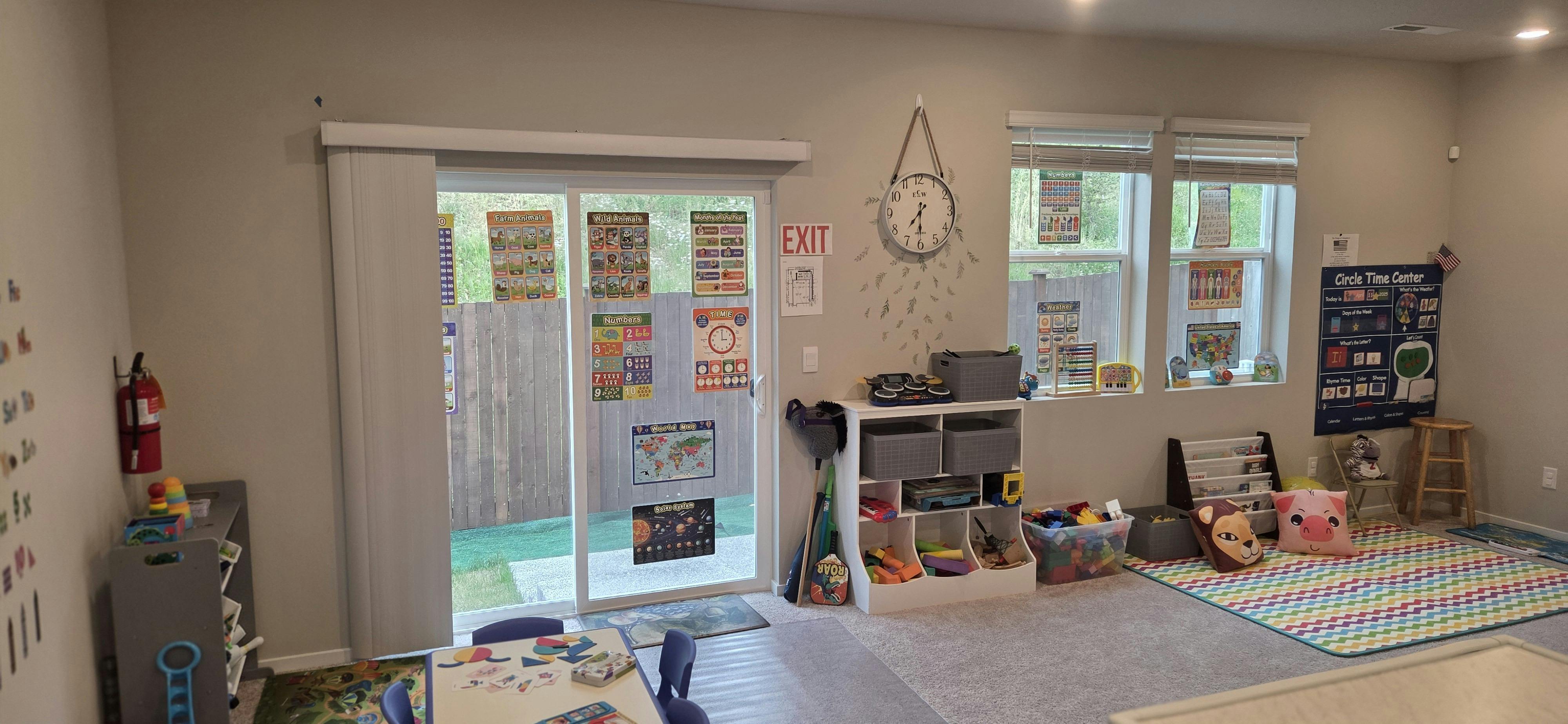 Playroom with sliding glass door, windows, and colorful rugs