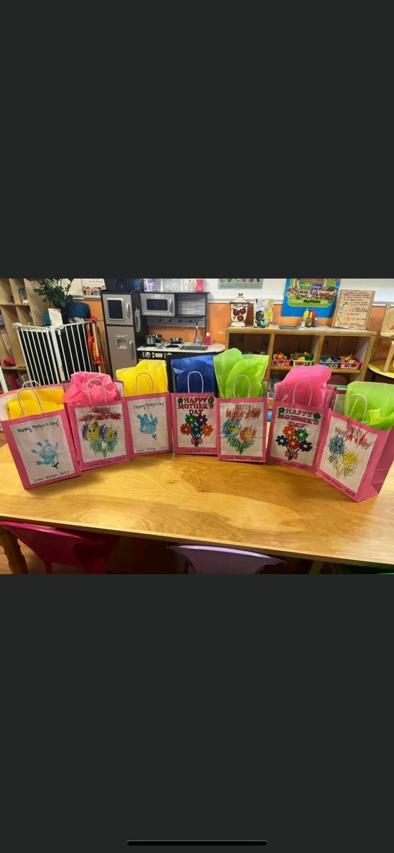 Gift bags with "Happy Mother's Day" cards on a table