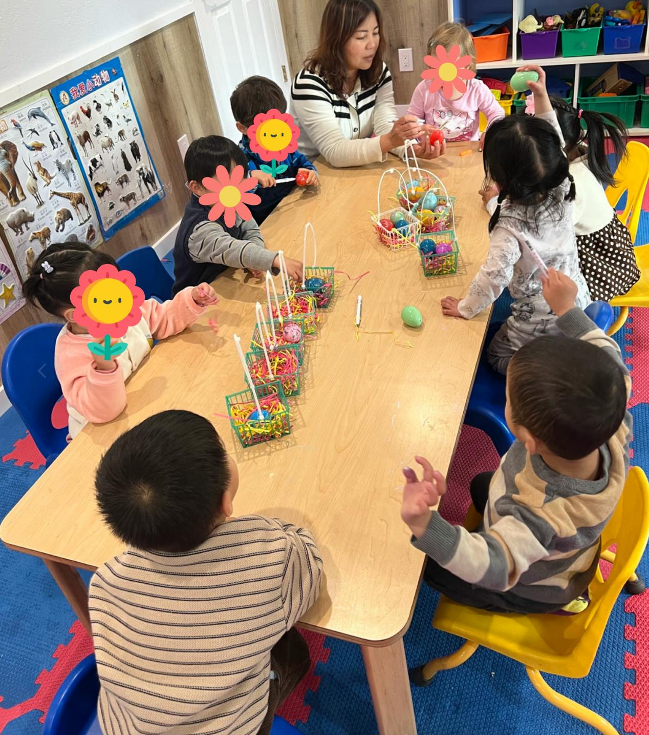 Adult and children sitting at a table with craft supplies