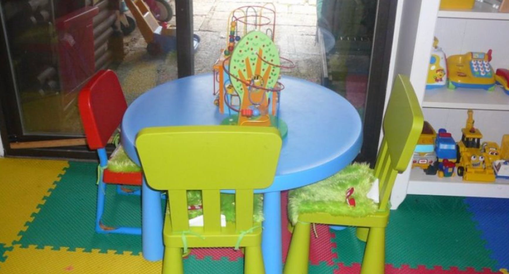 Child-sized table and chairs in a play area