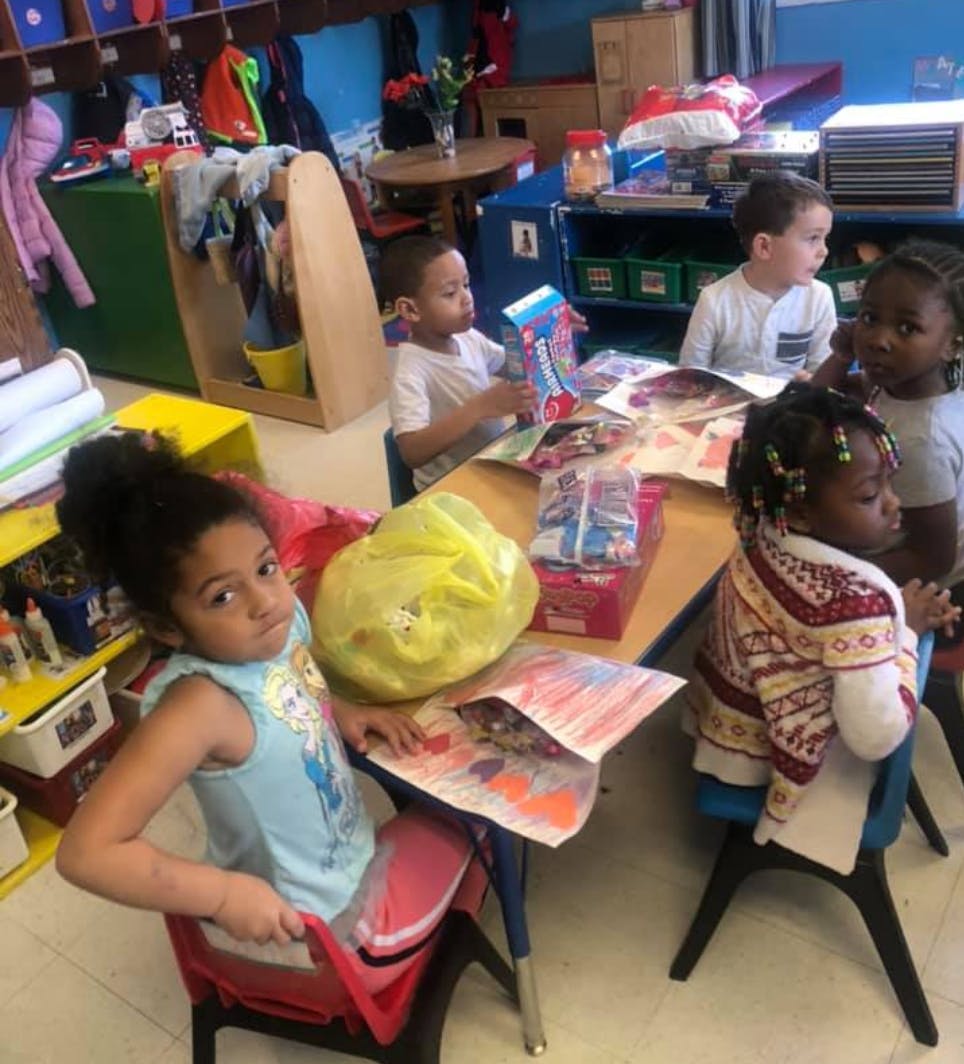 Children sitting at tables in a classroom