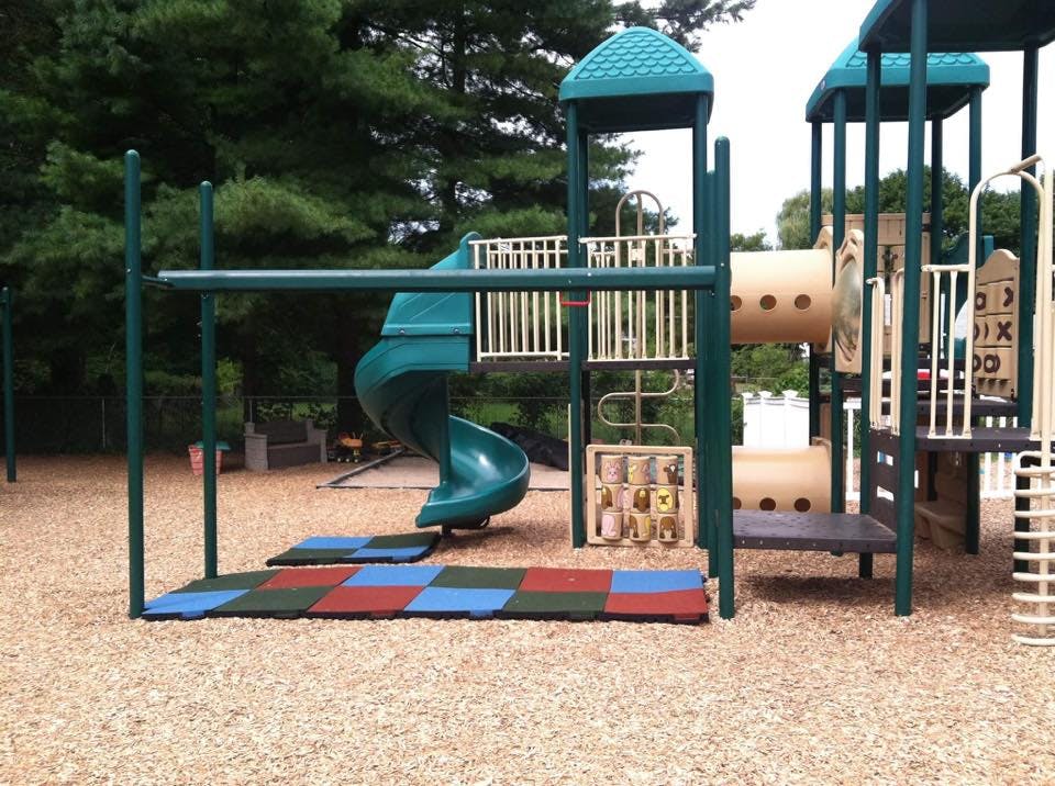 Playground with green slides and climbing structures
