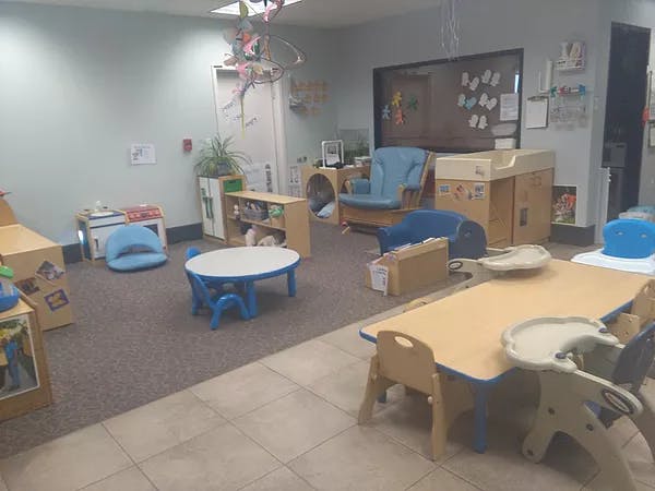 Empty classroom with small tables and chairs