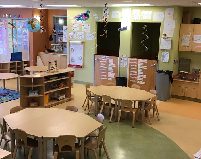 Classroom with small hexagonal tables and chairs