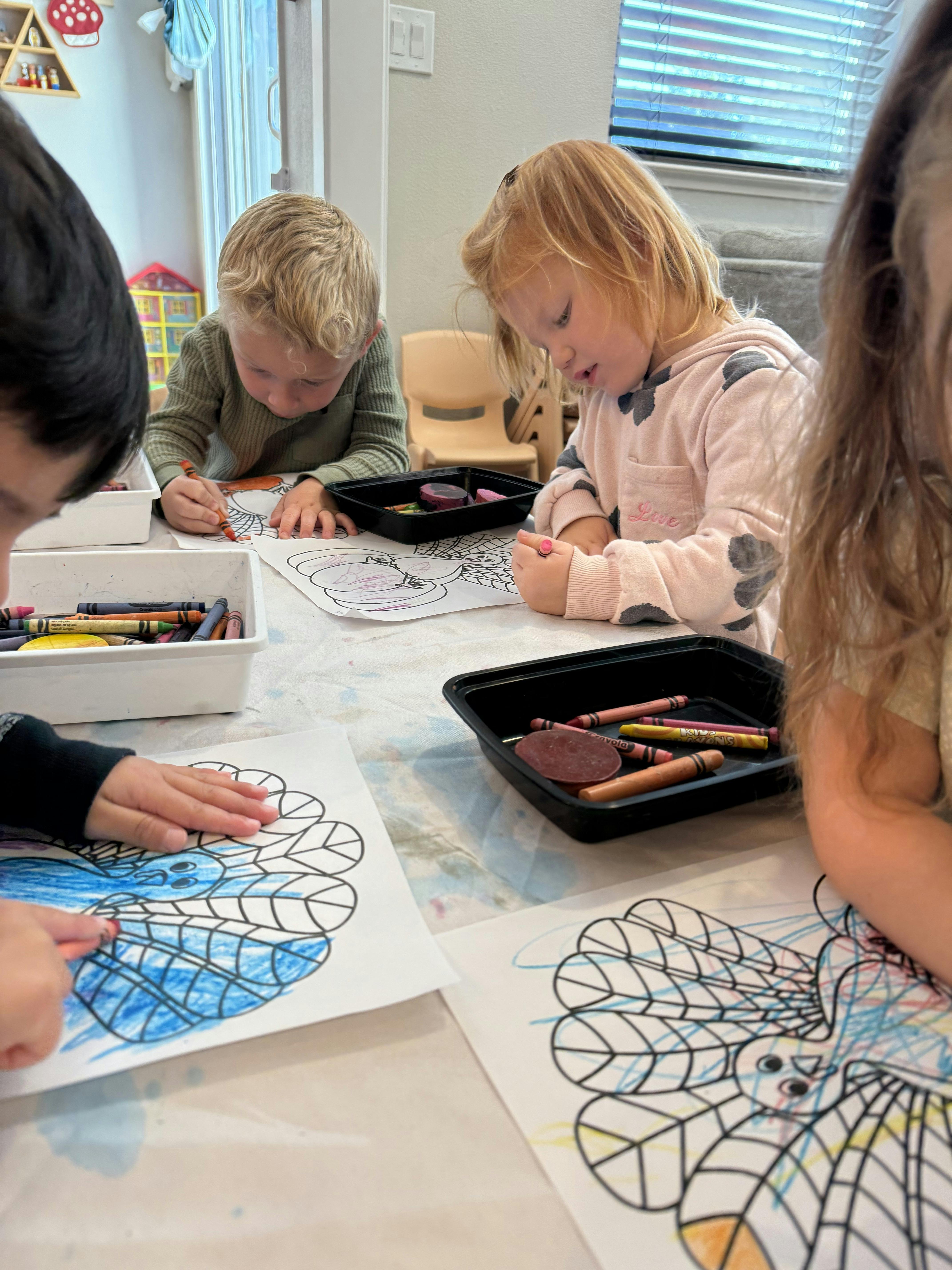 Children coloring at a table