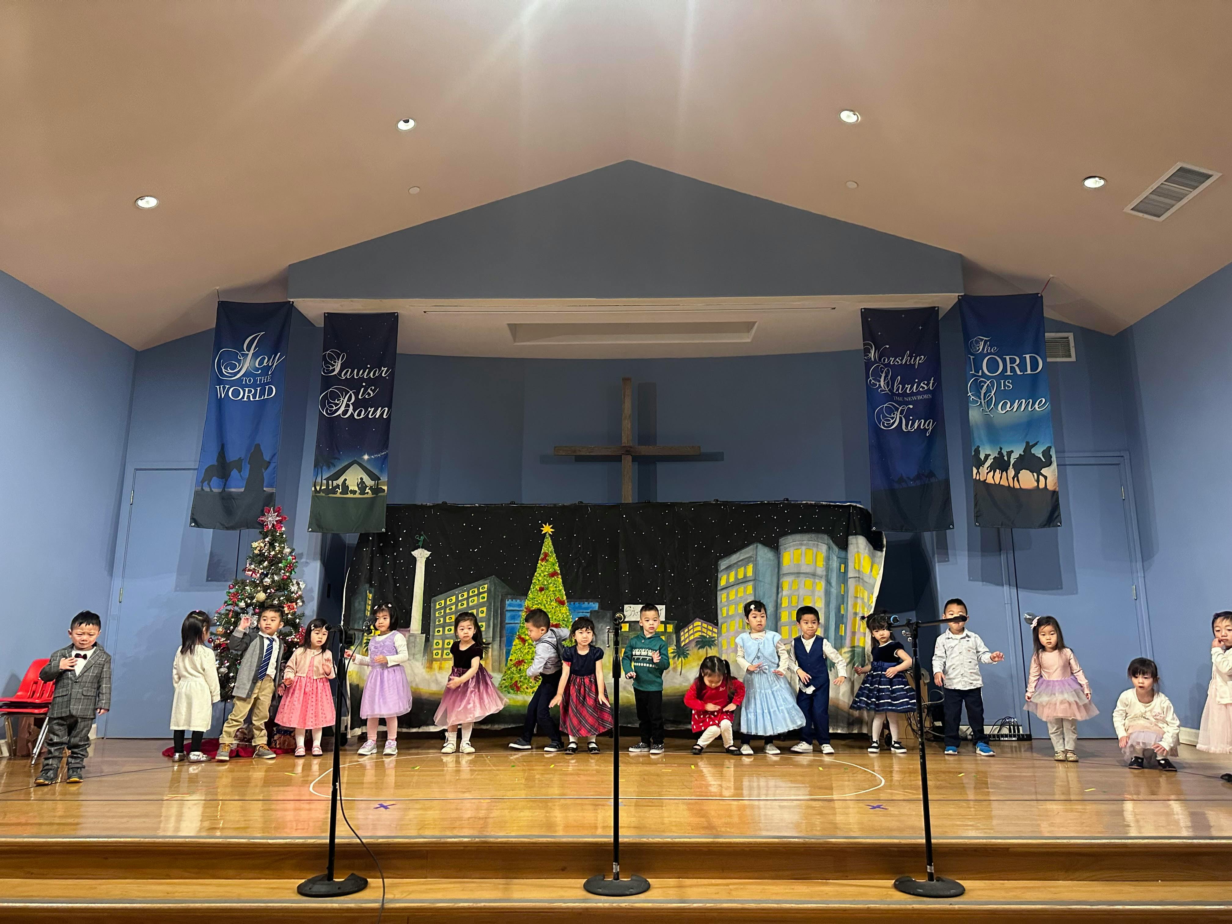 Group of children standing on a stage during a holiday performance