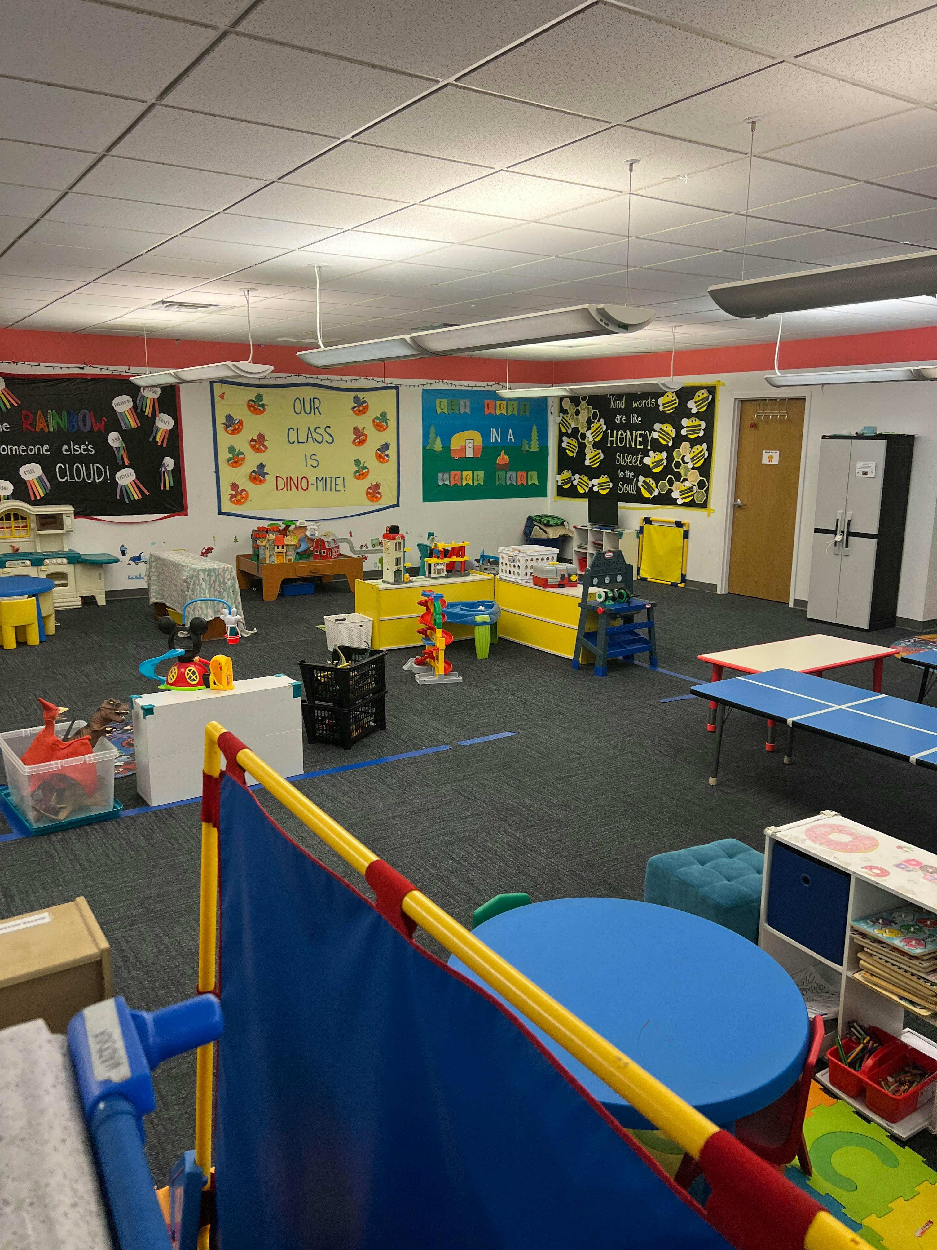 A classroom with colorful decorations and various play areas