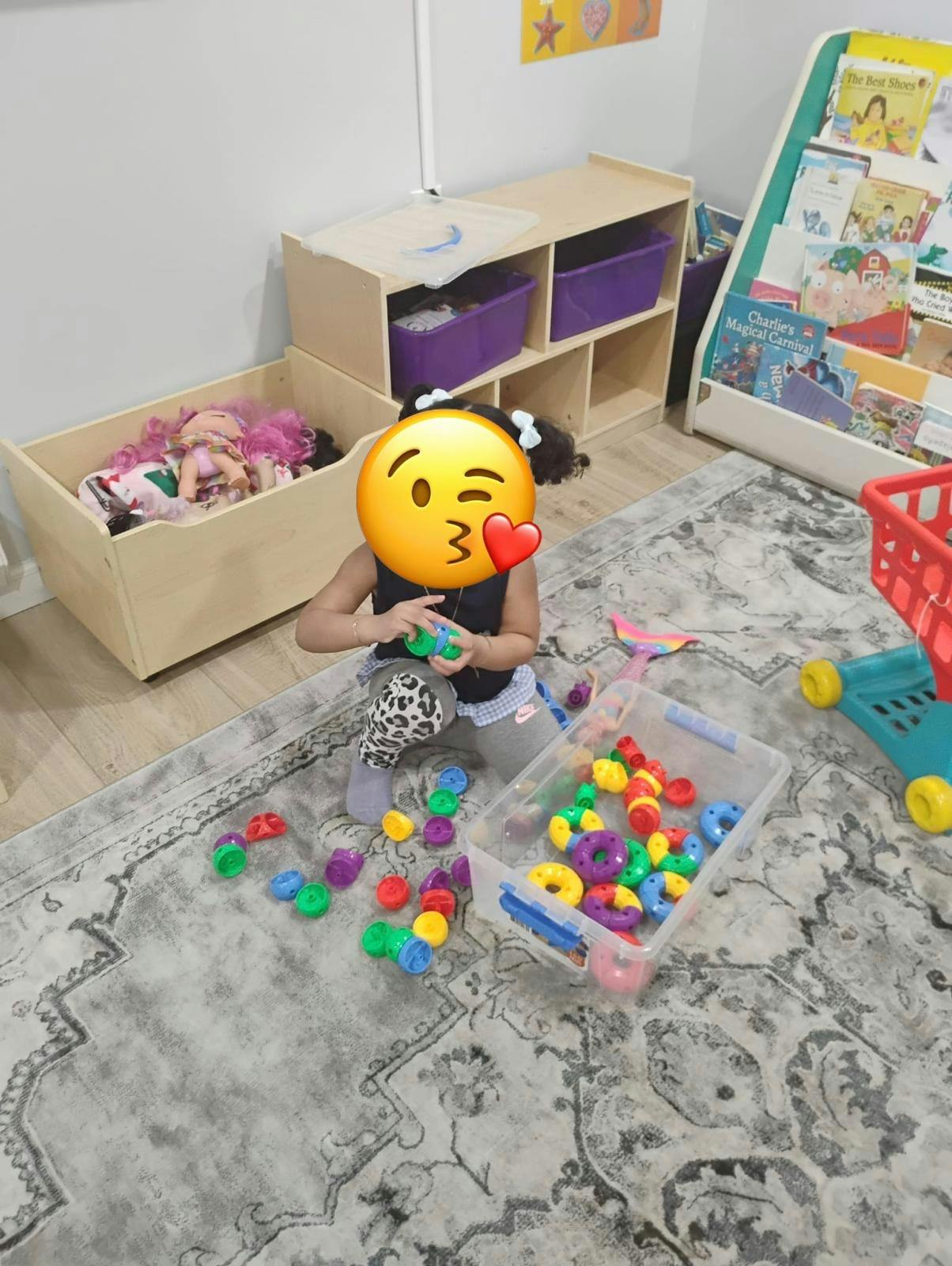 Child playing with colorful circular building blocks on a rug