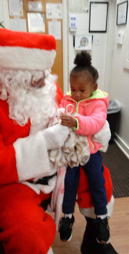 Person dressed as Santa holding a child on their lap