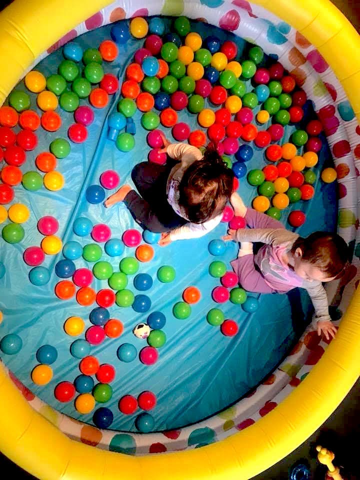 Two children playing in a ball pit