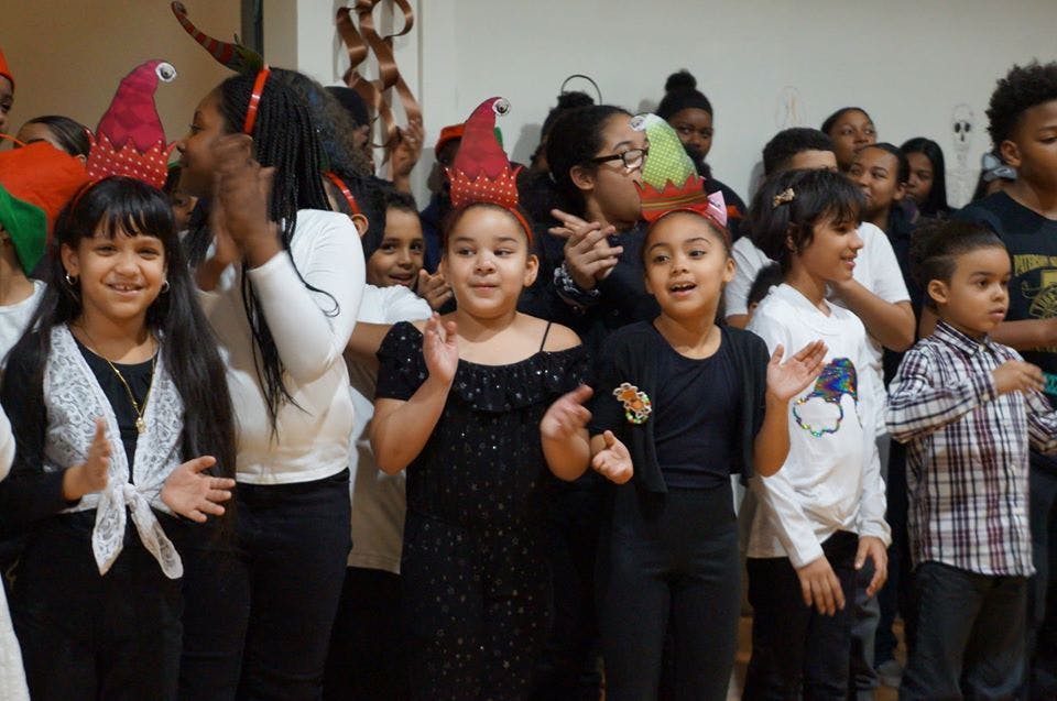 Group of children and adults clapping