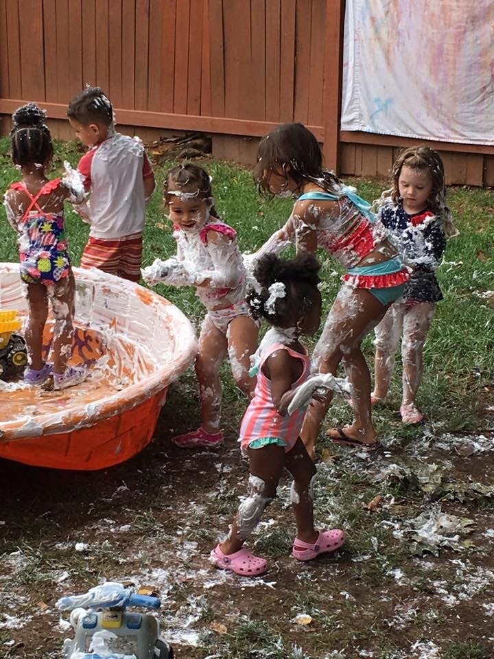 Children playing in foam outdoors