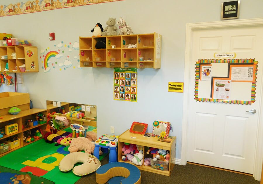 Playroom with toys, shelves, and a door