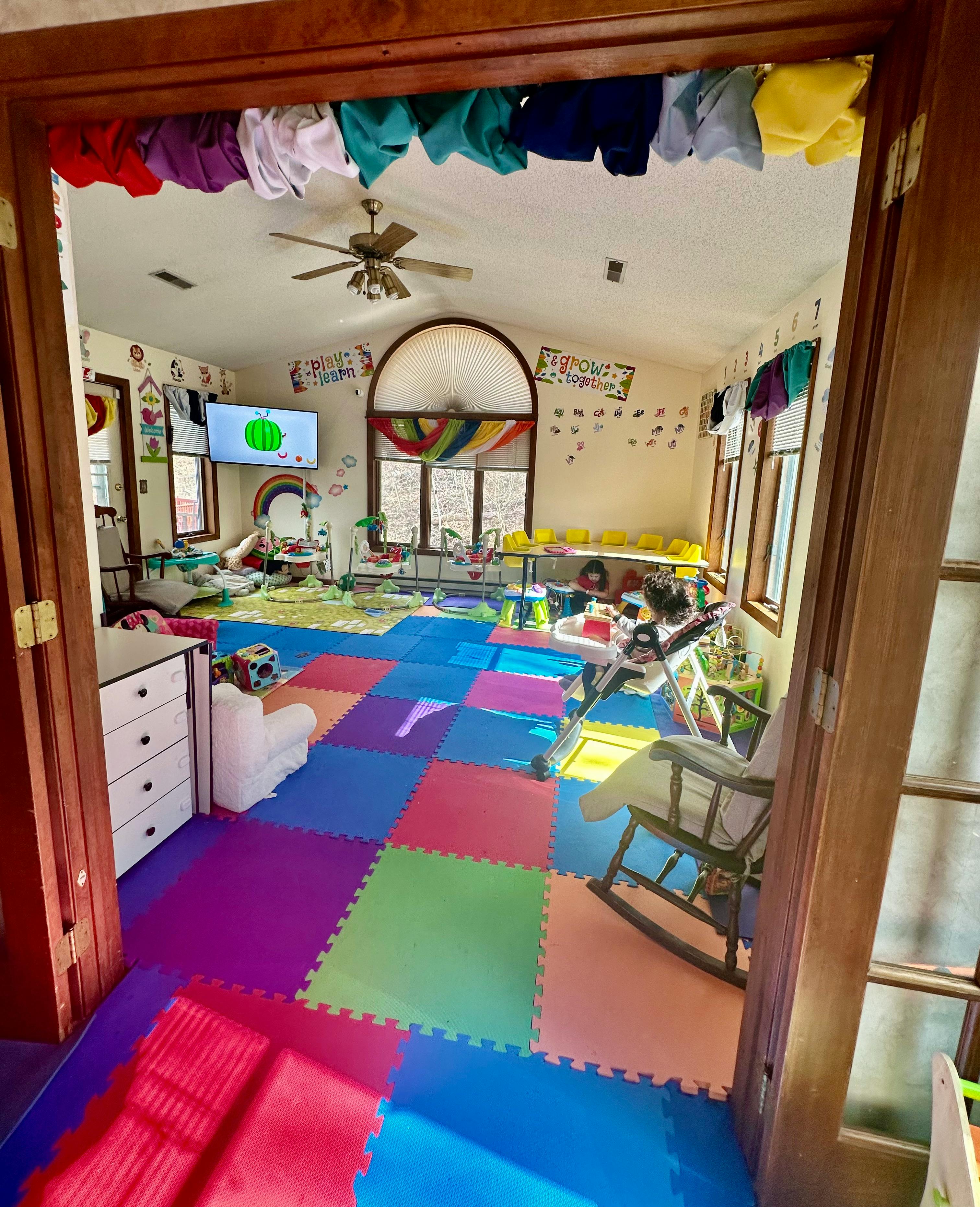 Playroom with colorful floor mats and various toys