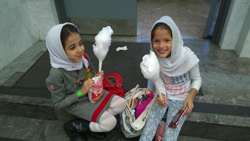 Two children holding cotton candy