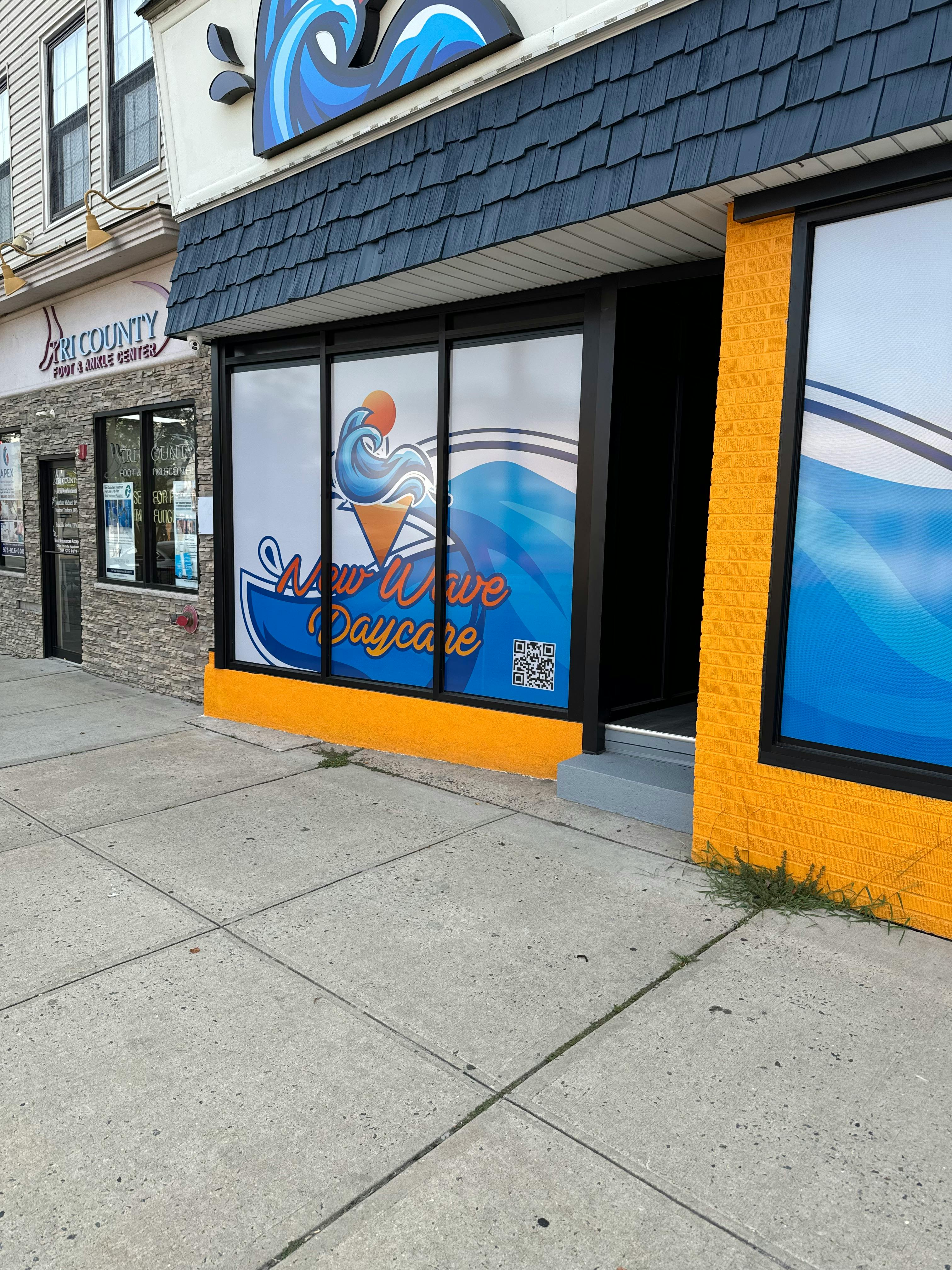 Storefront with "New Wave Daycare" sign on window