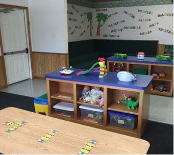 Classroom with tables and shelves of toys
