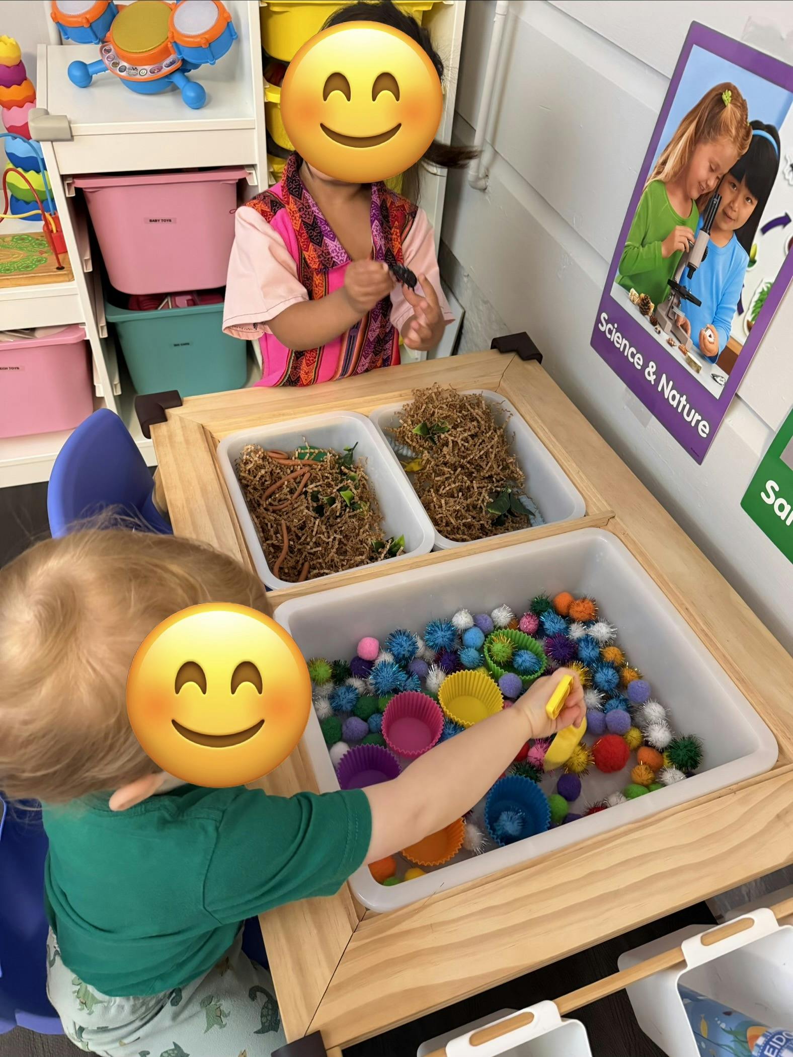 Children playing with sensory bins in a classroom