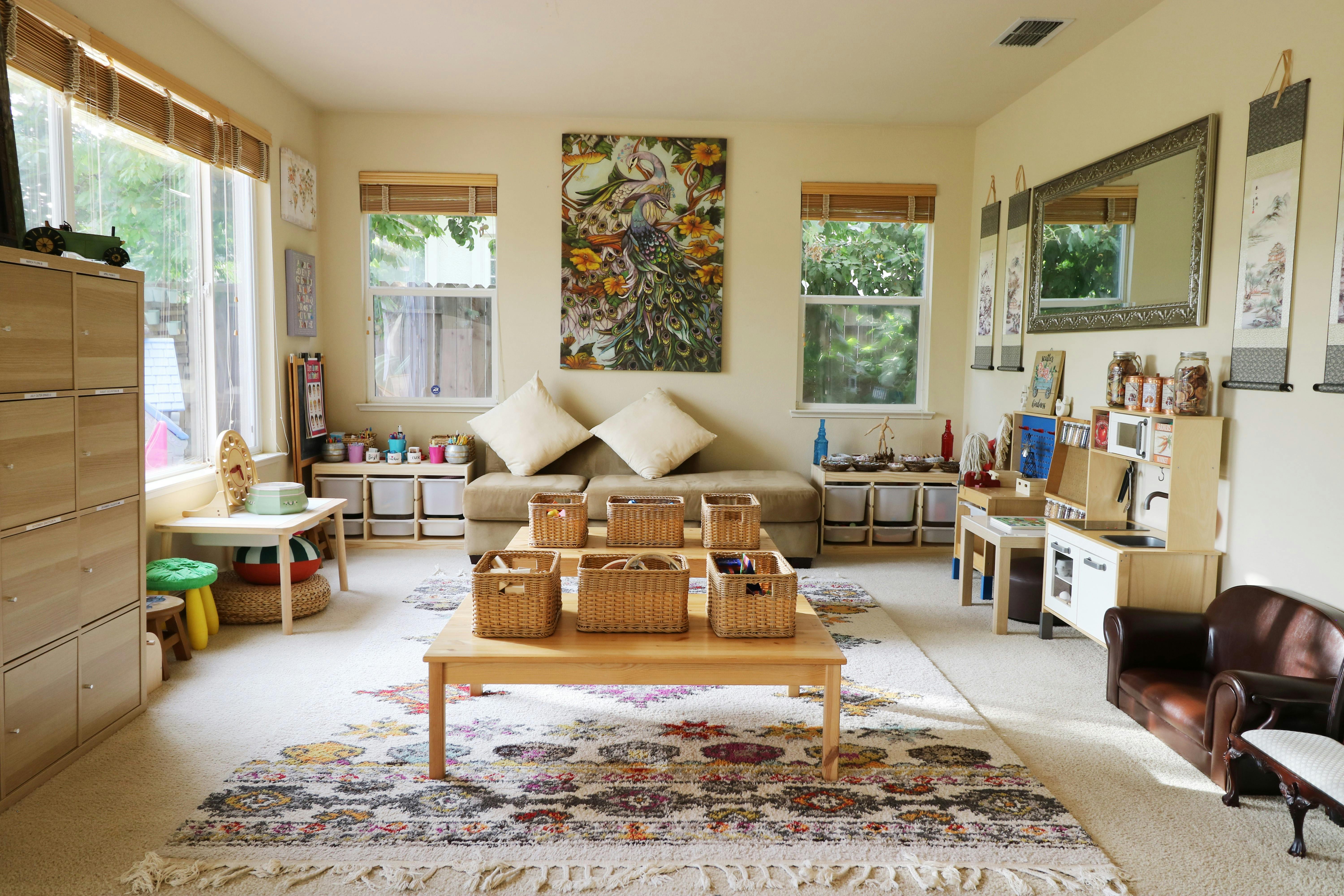 Living room with a sofa, coffee table with baskets, and windows