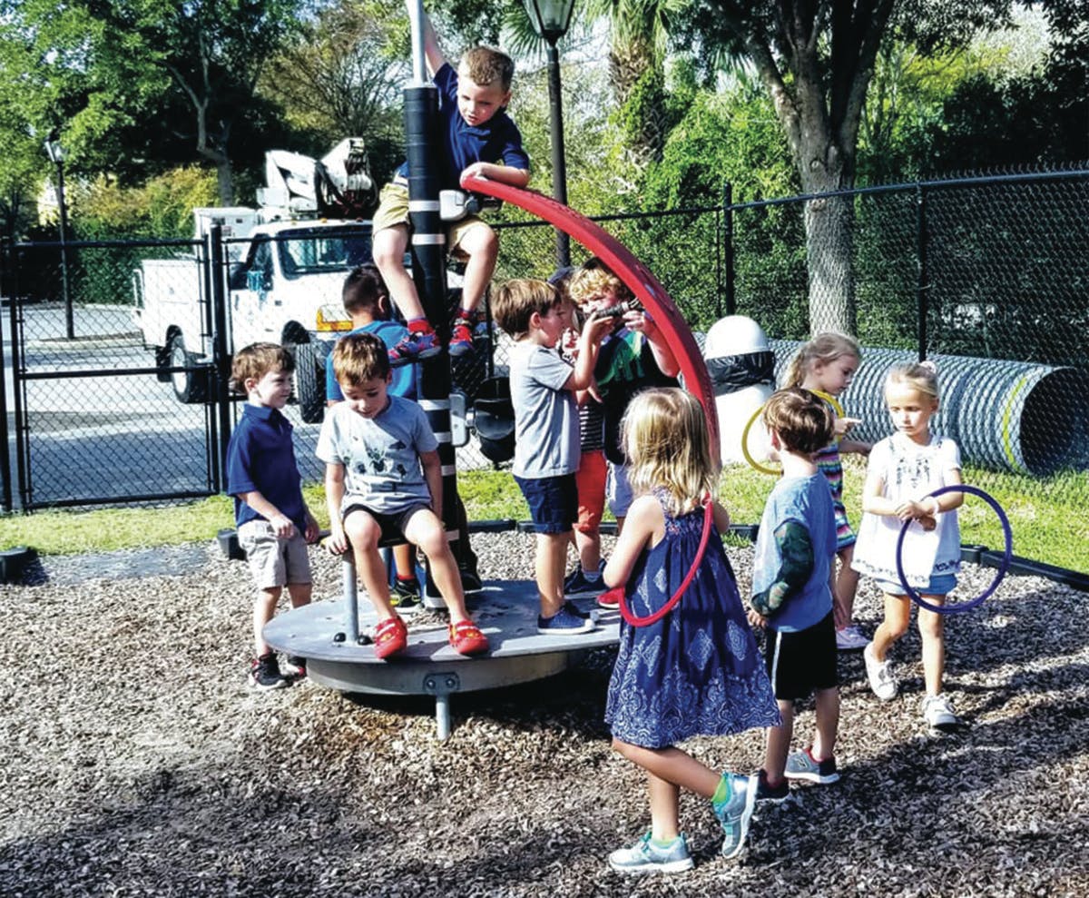 Children playing on a merry-go-round at a playground