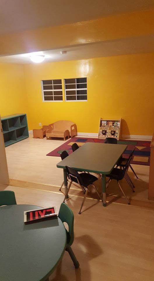 Classroom with tables, chairs, and a small couch