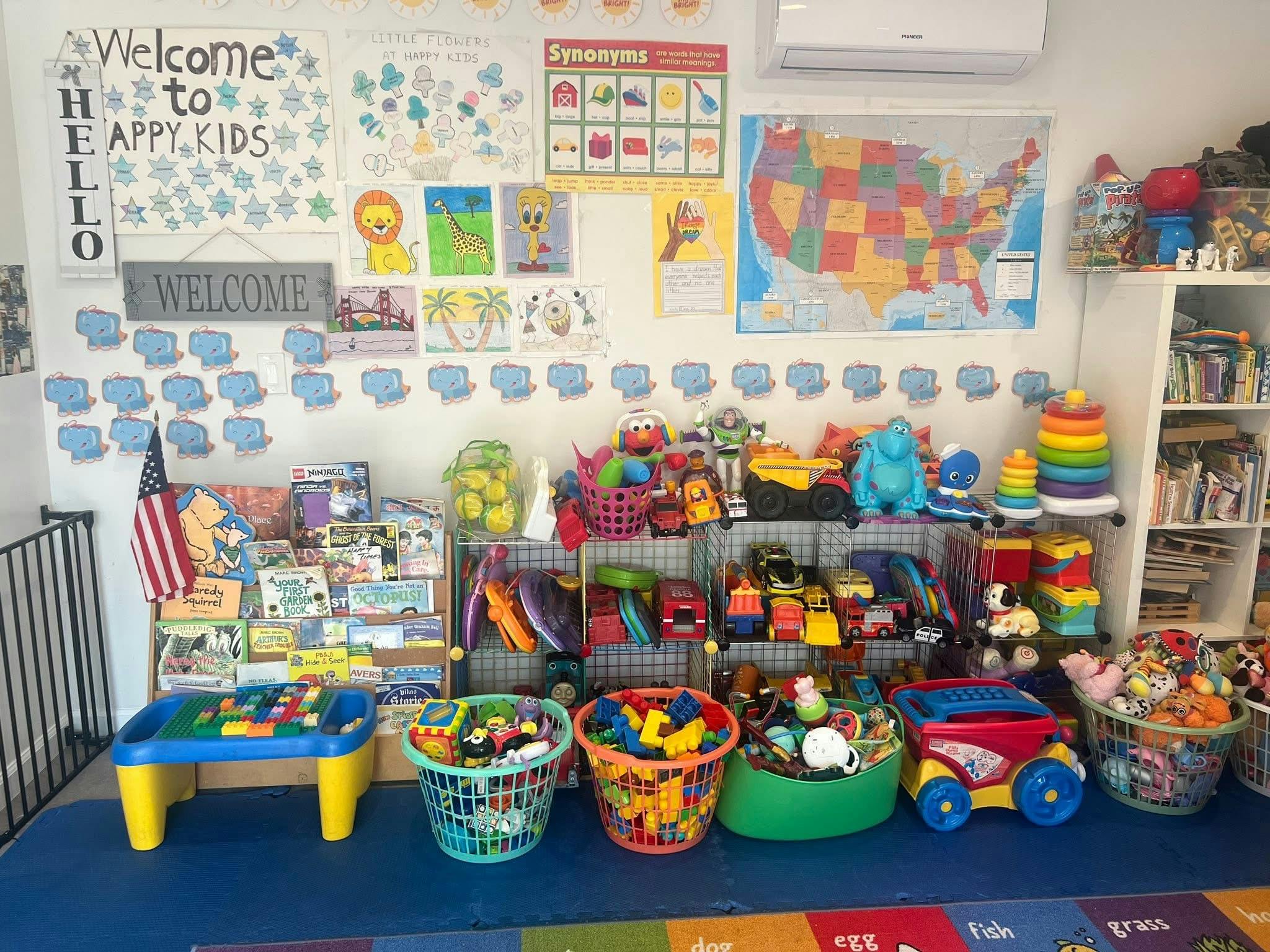 A playroom filled with educational wall charts, book displays, and toy baskets