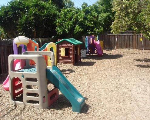 Playground with multiple slides, playhouses, and swings