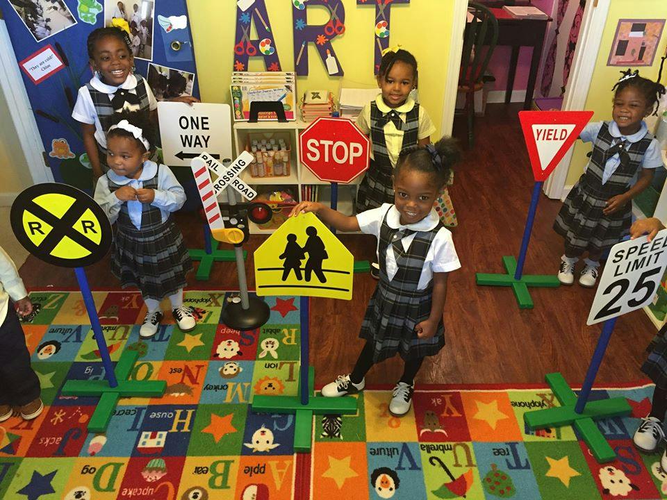 Children in a classroom with toy traffic signs