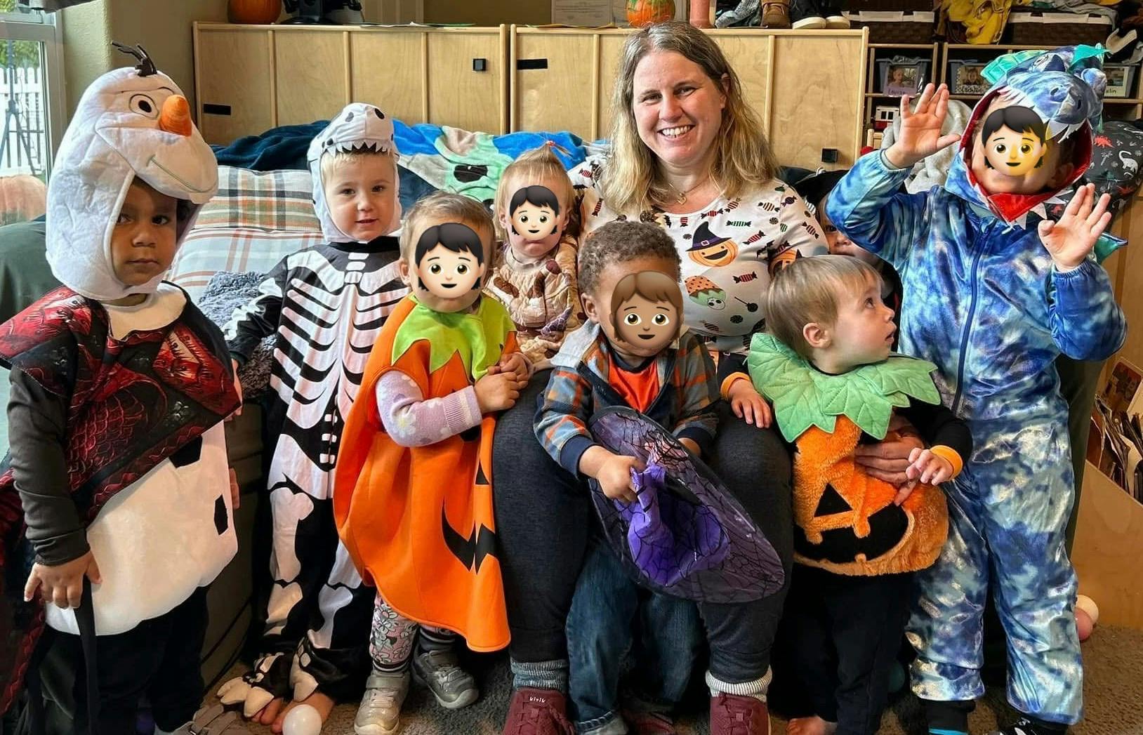 Adult and multiple children in Halloween costumes
