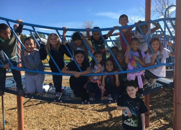 Group of children on a playground climbing structure