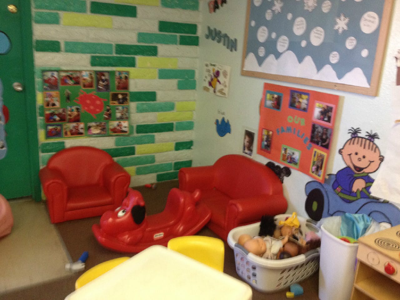 Children's play area with red chairs and toys