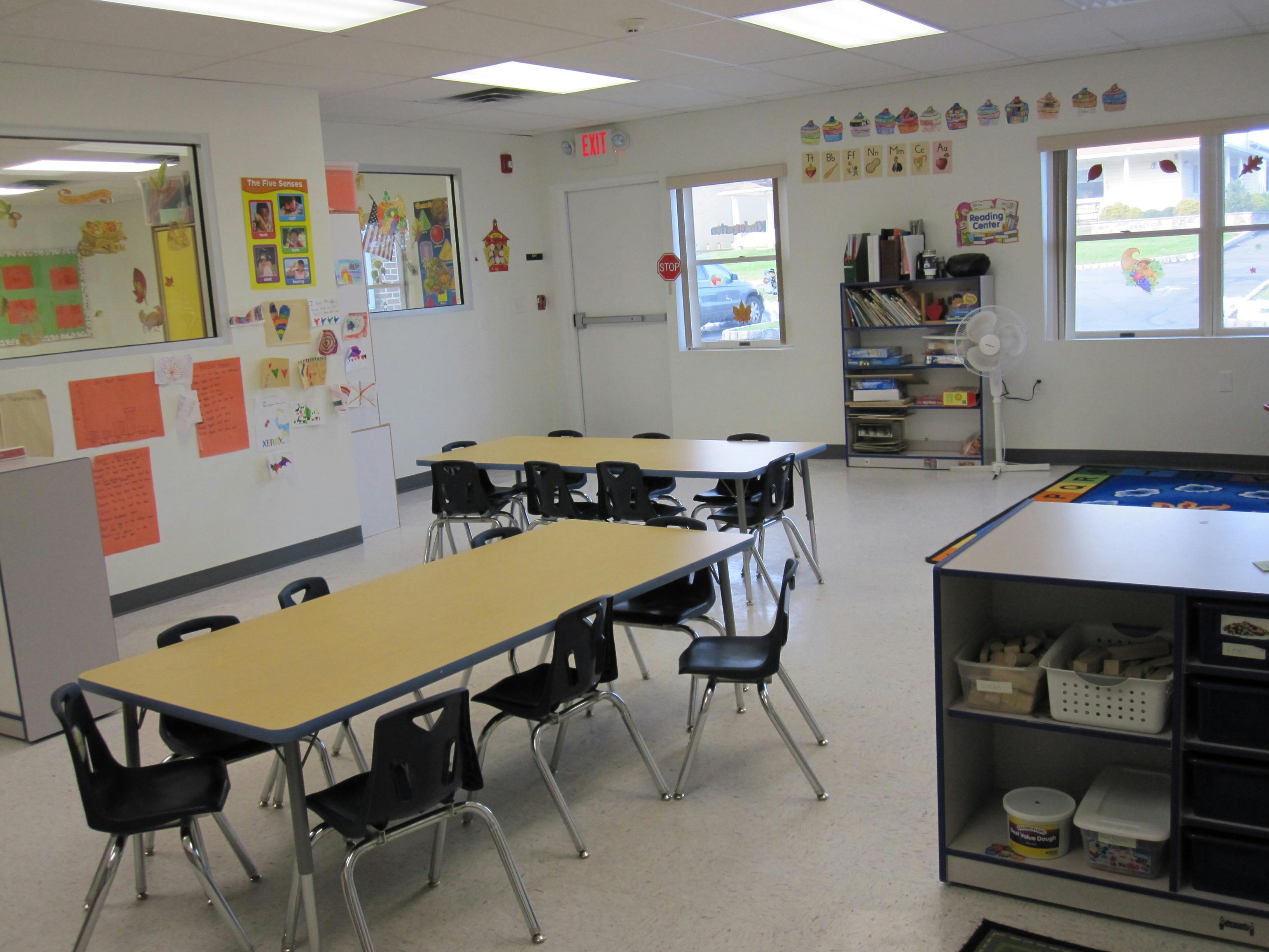 Empty classroom with small tables and chairs