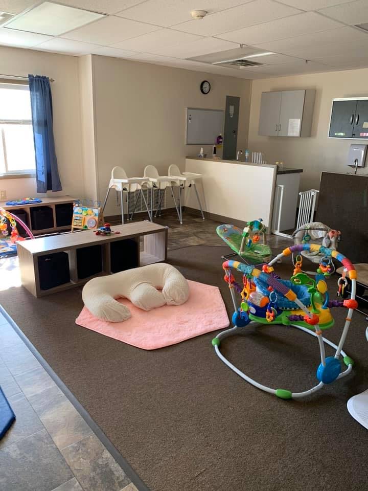 Playroom with baby bouncer, high chairs, and play mat