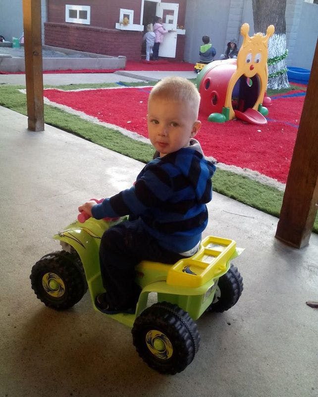 Child on a toy ATV
