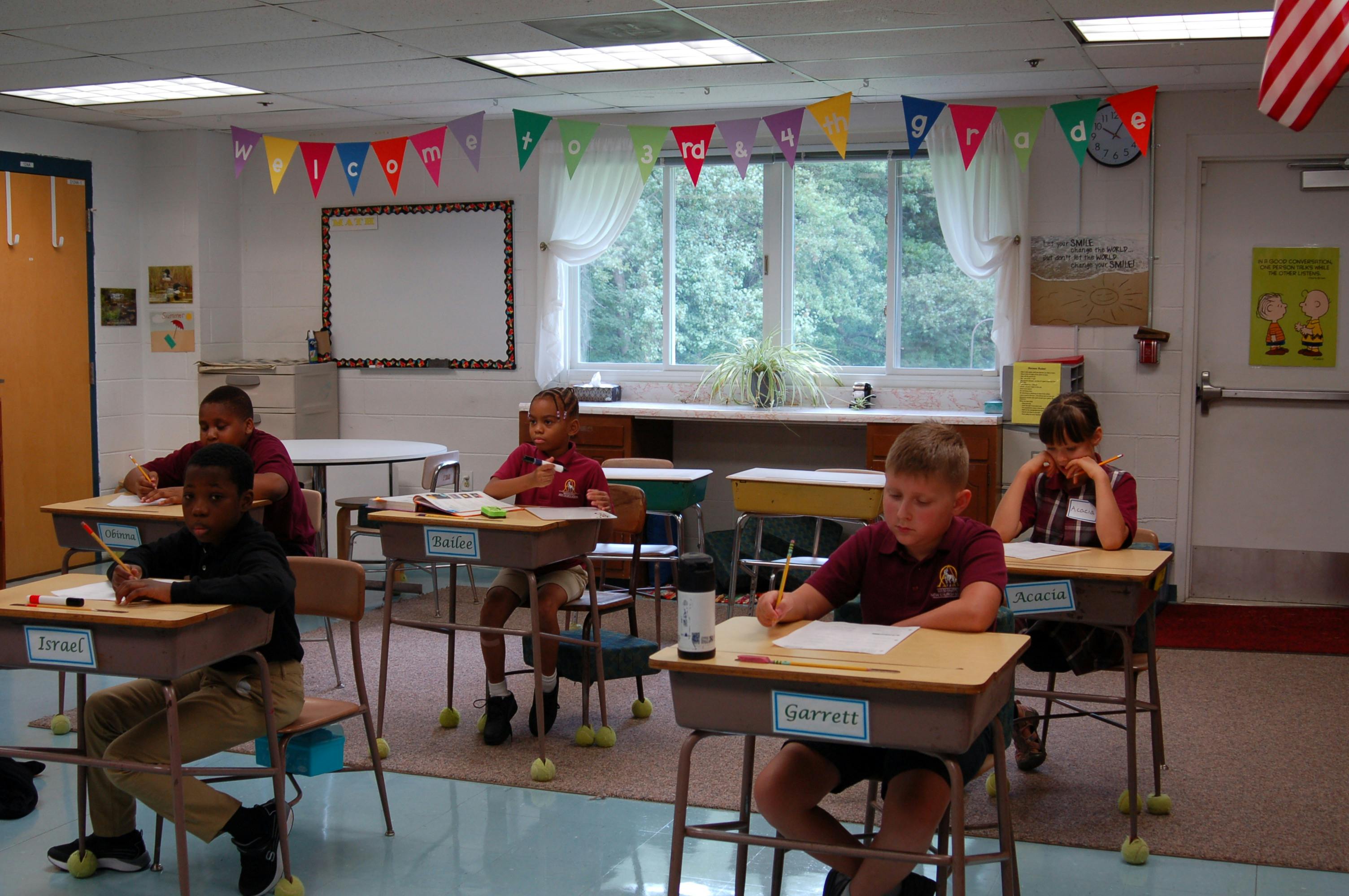 Children sitting at desks in a classroom