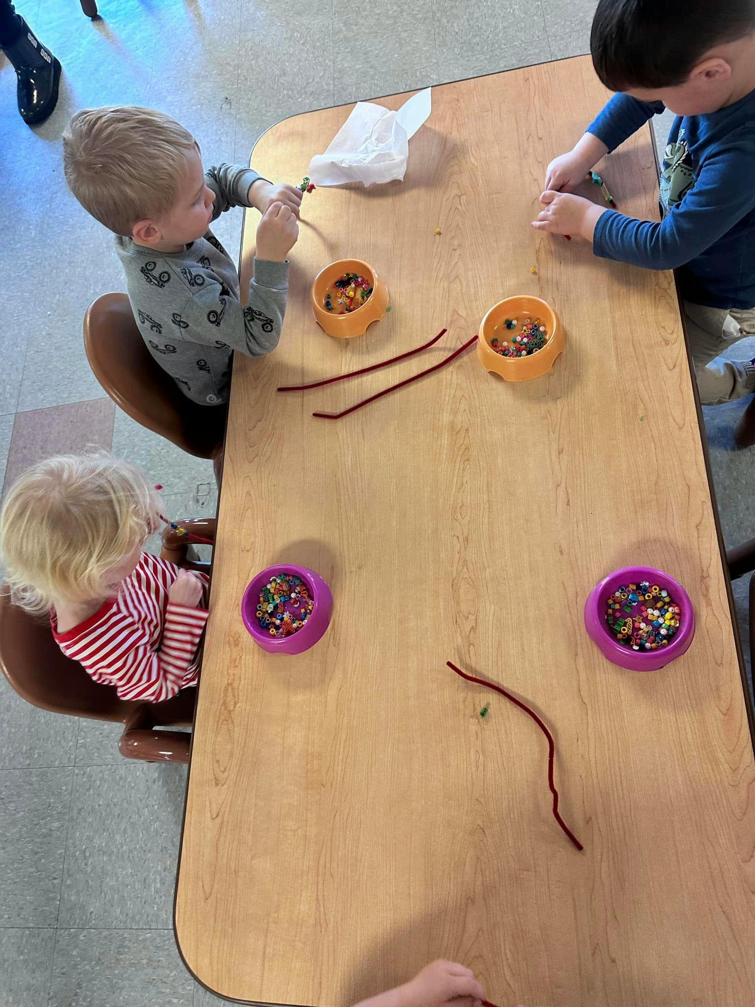 Children at a table with craft supplies