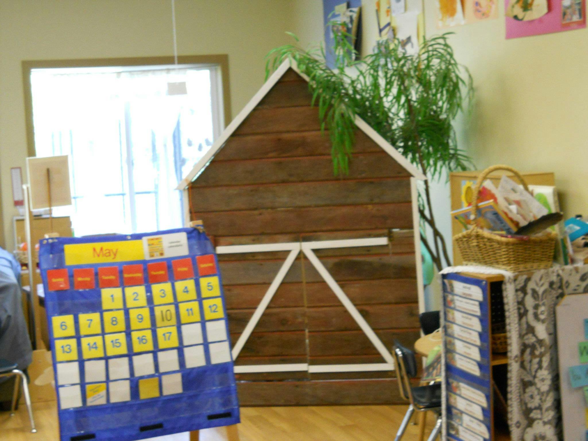 Classroom with a large calendar and a wooden barn prop