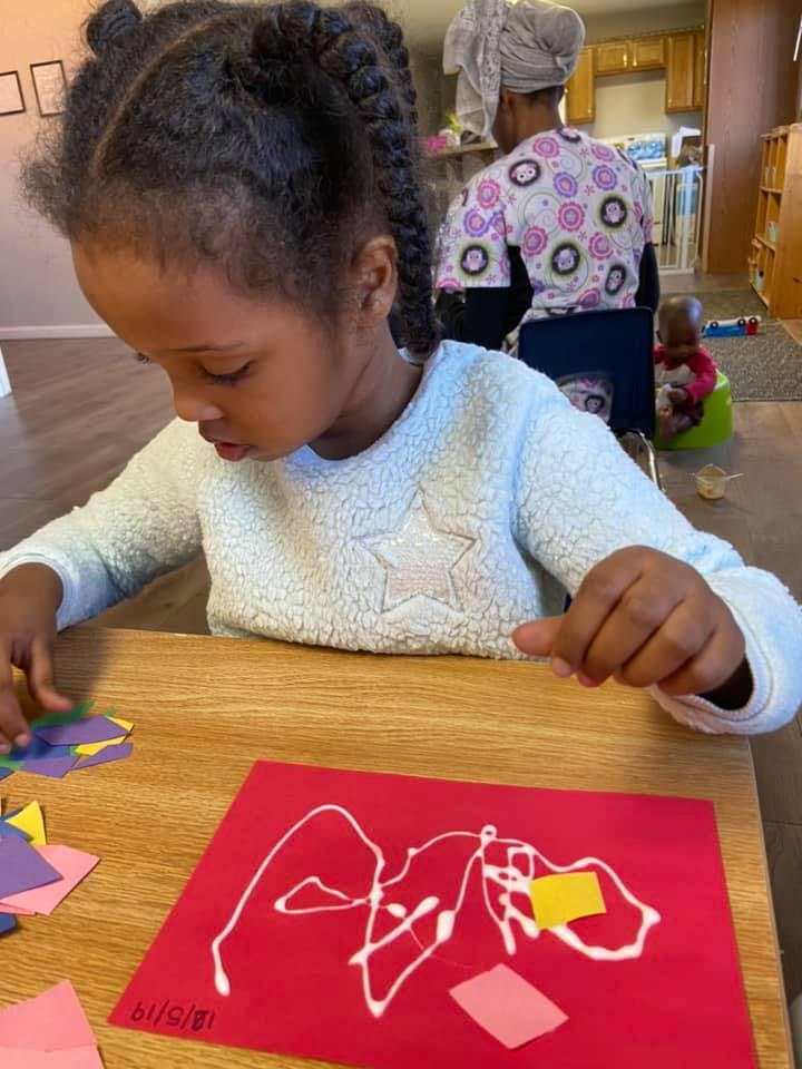 Child doing an art project at a table
