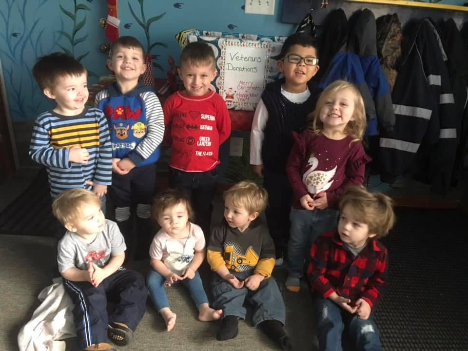 Group of children posing in a classroom