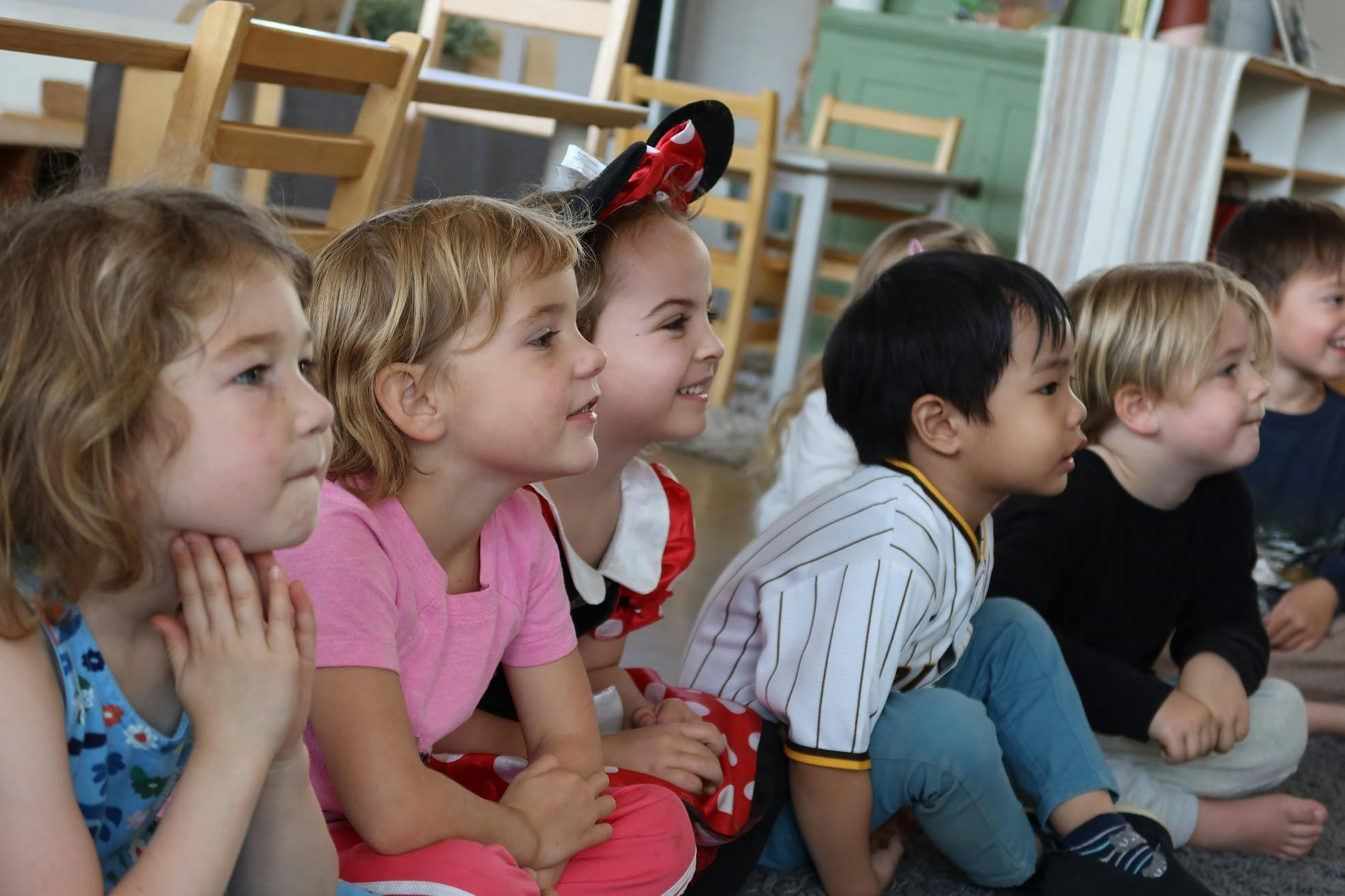 Group of children sitting and looking in the same direction